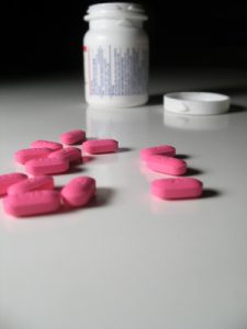 pink pills with bottle