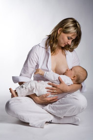 A mother nursing her infant.