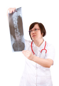 female doctor looking at x-ray of spina, backbone